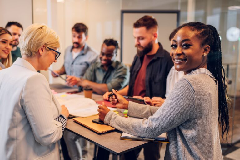 A team of multinational workers discussing a project at a large table